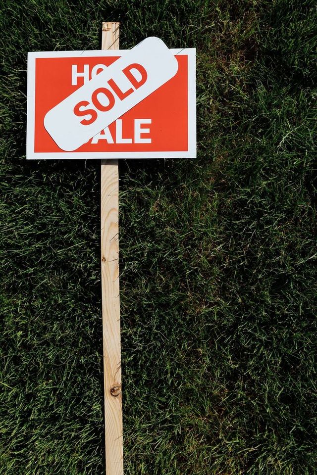 Sold sign on a front lawn